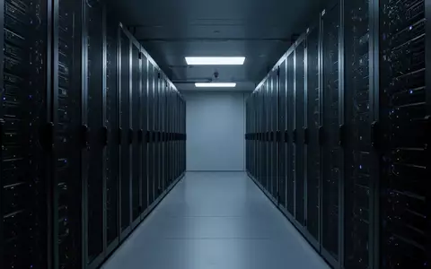 Ein moderner Serverraum mit ordentlich angeordneten, dunklen Serverschränken in kühler, blauer Beleuchtung. - Foto: über boerse-global.de