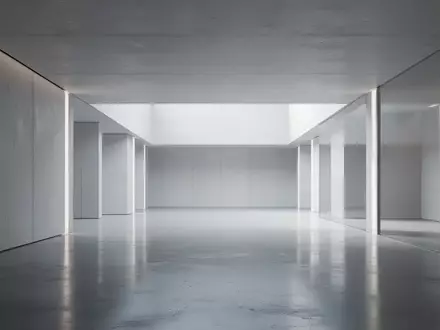 Ein minimalistisches, modernes Architekturinterieur mit klaren Linien und diffusem Licht, das auf polierten Betonböden reflektiert. - Foto: über boerse-global.de