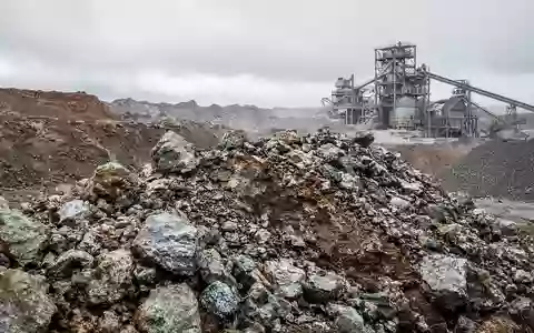 Industrielle Abbaustätte für Seltene Erden mit Erdhaufen und mineralischen Rohstoffen bei natürlichem Tageslicht. - Foto: über boerse-global.de