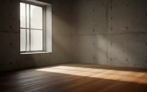 Ein minimalistischer, lichtdurchfluteter Raum mit sanften Schattenwürfen auf einer leeren Wand, der Ruhe und Zeitlichkeit vermittelt. - Foto: über boerse-global.de