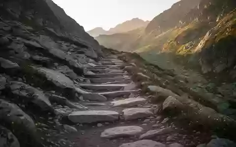 Ein steiler, felsiger Bergwanderpfad führt in einer alpinen Landschaft nach oben. - Foto: über boerse-global.de