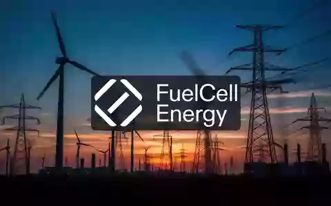 Abstrakte Industrielandschaft mit Windkraftanlagen bei Dämmerung, die die Stimmung im Energiesektor symbolisiert. - Foto: über boerse-global.de