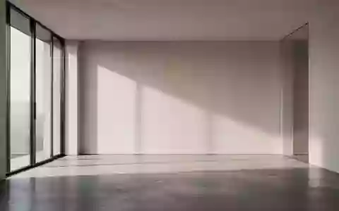 Ein minimalistischer, moderner Innenraum mit klaren Linien und natürlichem Lichteinfall auf einer glatten Betonwand. - Foto: über boerse-global.de