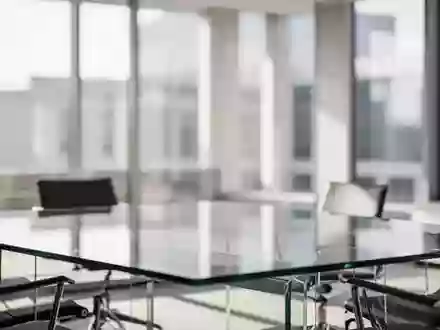 Ein minimalistischer, leerer Konferenzraum mit einem gläsernen Besprechungstisch und hellem Tageslicht. - Foto: über boerse-global.de