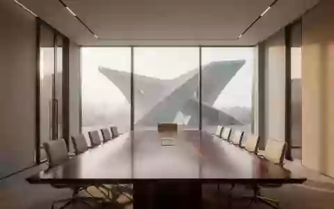 Ein moderner, minimalistischer Konferenzraum mit einem großen Holztisch und leeren Stühlen in hellem Tageslicht. - Foto: über boerse-global.de