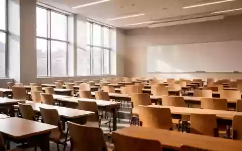 Ein moderner, leerer Hörsaal mit hölzernen Sitzreihen und hellem Tageslicht in einer Universität. - Foto: über boerse-global.de