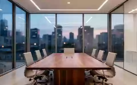 Ein minimalistischer, moderner Konferenzraum mit einem großen Holztisch und bodentiefen Fenstern vor einer Stadtkulisse. - Foto: über boerse-global.de