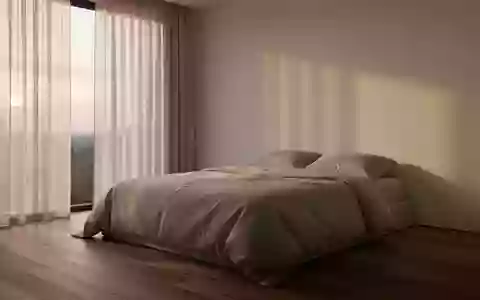 Ein minimalistisch eingerichtetes Schlafzimmer mit einem unbenutzten, ordentlich gemachten Bett im sanften Morgenlicht. - Foto: über boerse-global.de