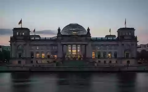 Das Reichstagsgebäude in Berlin in der Abenddämmerung, gesehen über die Spree. - Foto: über boerse-global.de