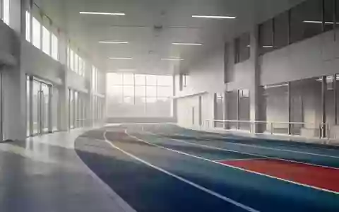 Ein minimalistischer, heller Innenraum einer Sportanlage mit einer Laufbahn bei Tageslicht. - Foto: über boerse-global.de