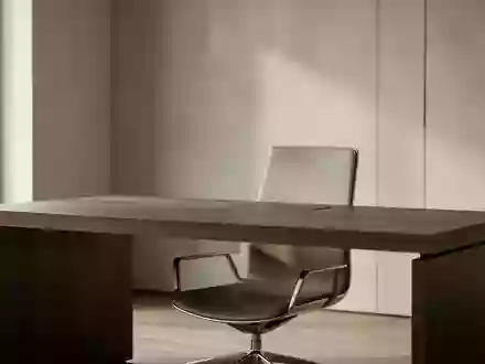 Ein minimalistisch gestalteter, aufgeräumter Arbeitsplatz mit einem dunklen Holztisch und einem ergonomischen Stuhl. - Foto: über boerse-global.de