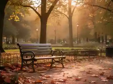 Eine leere Parkbank in einem sonnendurchfluteten Garten im Herbst, die Ruhe und Verbundenheit symbolisiert. - Foto: über boerse-global.de