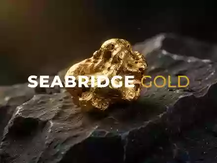 Ein goldener Nugget auf dunklem Gestein als Symbol für den Bergbau und die Edelmetallbranche. - Foto: über boerse-global.de