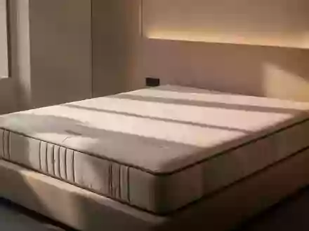 Ein minimalistisch gestaltetes Schlafzimmer mit einer hochwertigen Matratze in einem hellen, aufgeräumten Raum. - Foto: über boerse-global.de