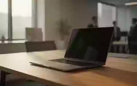 Ein moderner, minimalistischer Arbeitsplatz mit einem Laptop auf einem Schreibtisch in hellem, natürlichem Tageslicht. - Foto: über boerse-global.de