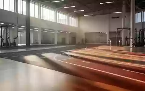 Eine leere, moderne Laufbahn in einer hellen Sporthalle mit natürlichem Lichteinfall und poliertem Holzboden. - Foto: über boerse-global.de