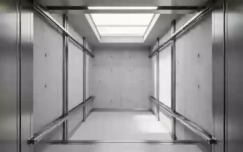 Ein minimalistischer Blick in einen leeren Aufzugsschacht mit Stahlschienen und Betonwänden. - Foto: über boerse-global.de