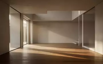 Ein minimalistischer, leerer Raum mit klaren architektonischen Linien und sanftem Lichteinfall auf einem Holzboden. - Foto: über boerse-global.de