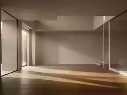 Ein minimalistischer, leerer Raum mit klaren architektonischen Linien und sanftem Lichteinfall auf einem Holzboden. - Foto: über boerse-global.de