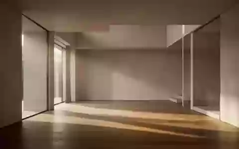Ein minimalistischer, leerer Raum mit klaren architektonischen Linien und sanftem Lichteinfall auf einem Holzboden. - Foto: über boerse-global.de