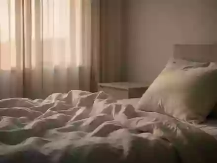 Ein minimalistisches, ruhiges Schlafzimmer bei Tagesanbruch mit weißer Bettwäsche und sanftem Morgenlicht. - Foto: über boerse-global.de