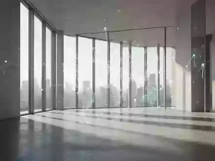 Ein minimalistischer, moderner Innenraum mit hellem Tageslicht und langen Schatten auf einem Betonboden. - Foto: über boerse-global.de