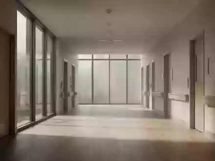 Ein leerer, sonnendurchfluteter Flur in einer modernen Pflegeeinrichtung mit minimalistischer Architektur. - Foto: über boerse-global.de