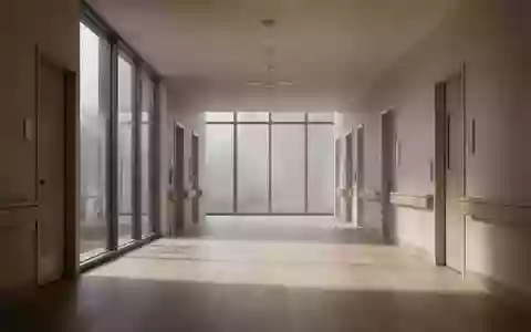 Ein leerer, sonnendurchfluteter Flur in einer modernen Pflegeeinrichtung mit minimalistischer Architektur. - Foto: über boerse-global.de