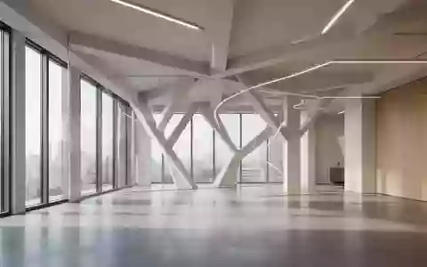 Ein minimalistisch gestalteter, leerer Büroinnenraum mit klaren architektonischen Linien und natürlichem Lichteinfall. - Foto: über boerse-global.de