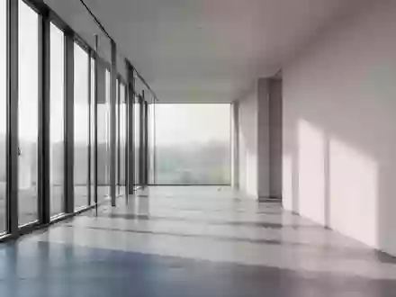 Ein minimalistischer Flur in einem modernen Verwaltungsgebäude mit großen Fenstern und natürlichem Lichteinfall. - Foto: über boerse-global.de