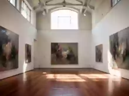 Ein lichtdurchfluteter, leerer Ausstellungsraum einer Kunstgalerie mit hohen Wänden und Holzboden. - Foto: über boerse-global.de