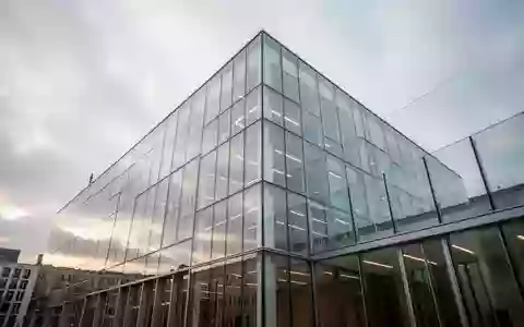 Moderne Glasfassade eines Bürogebäudes bei bewölktem Himmel in Berlin. - Foto: über boerse-global.de