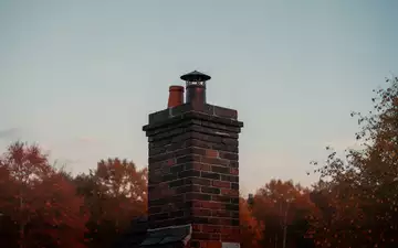 Ein gemauerter Schornstein vor einem herbstlichen Abendhimmel zu Beginn der Heizperiode. - Foto: über boerse-global.de