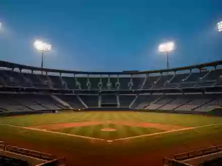 Ein leeres Baseballstadion in der Dämmerung mit Flutlichtbeleuchtung und unbesetzten Zuschauerrängen. - Foto: über boerse-global.de