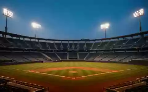 Ein leeres Baseballstadion in der Dämmerung mit Flutlichtbeleuchtung und unbesetzten Zuschauerrängen. - Foto: über boerse-global.de