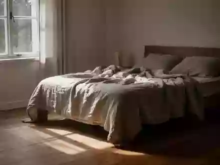 Ein sonnendurchflutetes Schlafzimmer mit einem ungemachten Bett in einer ruhigen, minimalistischen Umgebung. - Foto: über boerse-global.de