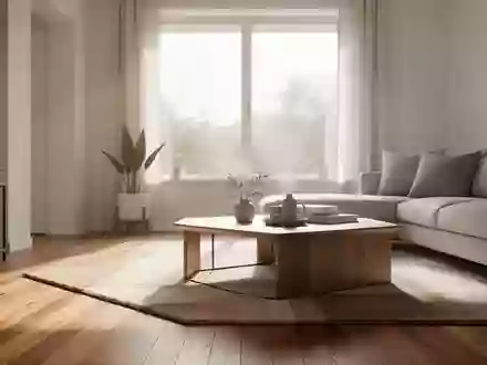 Ein aufgeräumtes, modernes Wohnzimmer mit hellem Parkettboden und natürlichem Lichteinfall durch ein großes Fenster. - Foto: über boerse-global.de
