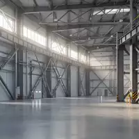 Eine moderne, leere Industriehalle mit hohen Decken und Stahlstrukturen bei natürlichem Lichteinfall. - Foto: über boerse-global.de