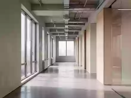 Ein minimalistischer, moderner Büroflur mit natürlichem Lichteinfall und klaren architektonischen Linien ohne Personen. - Foto: über boerse-global.de