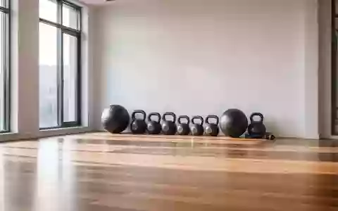 Ein minimalistischer Fitnessraum mit Holzboden, bei dem Hanteln und ein Medizinball ordentlich an einer weißen Wand stehen. - Foto: über boerse-global.de