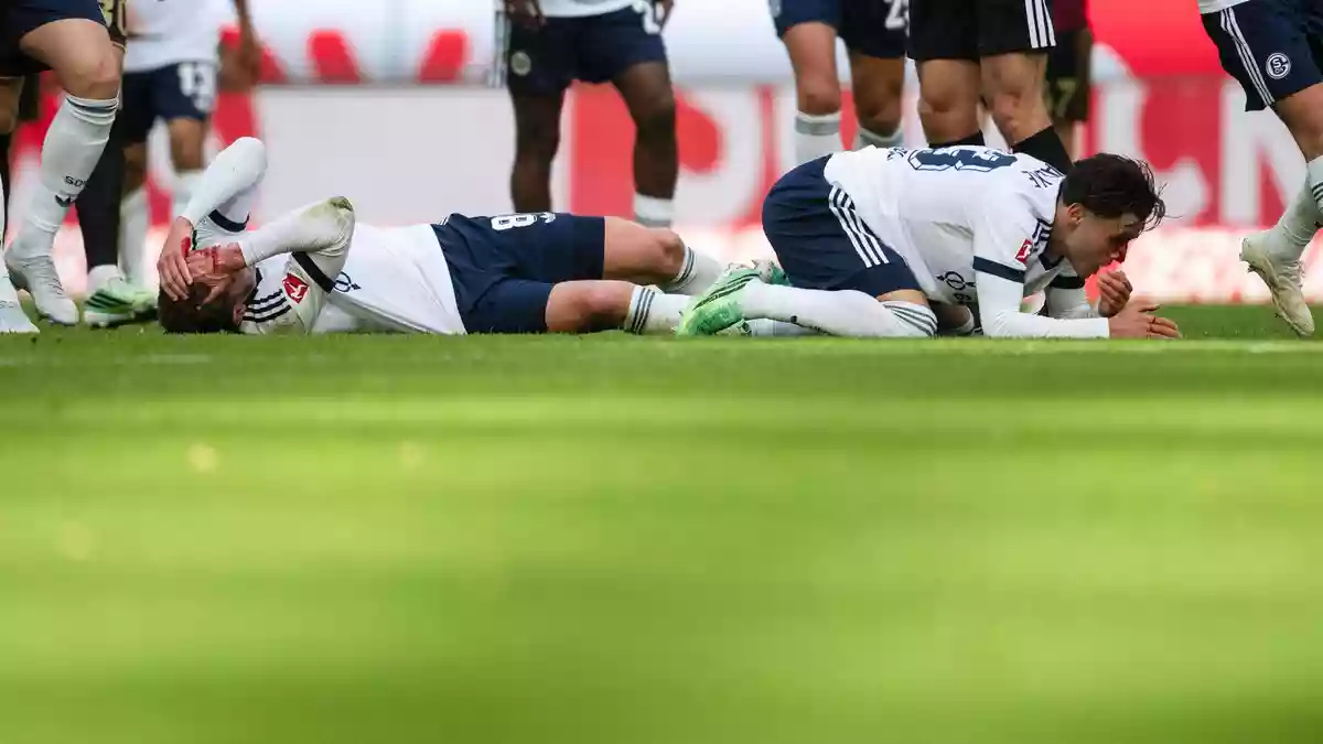 Robin Gosens und Soufiane El-Faouzi müssen nach einem Kopfzusammenstoß behandelt werden.  - Bild: Marius Becker/dpa