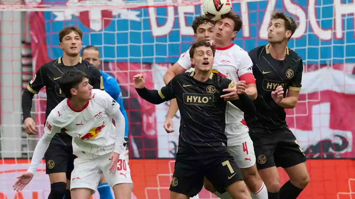  Maurice Krattenmacher (SV 07 Elversberg, vorne M) und Willi Orbán (RB Leipzig, 2.v.r) kämpfen um den Ball. - Bild: Hendrik Schmidt/dpa