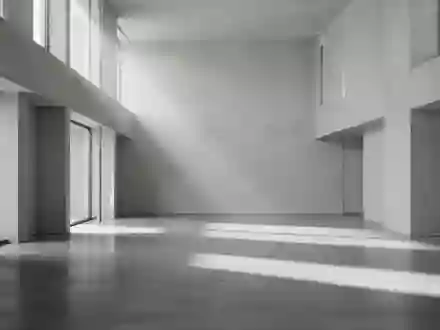 Ein minimalistischer, leerer Raum mit poliertem Betonboden und geometrischen Schattenwürfen durch einfallendes Tageslicht. - Foto: über boerse-global.de