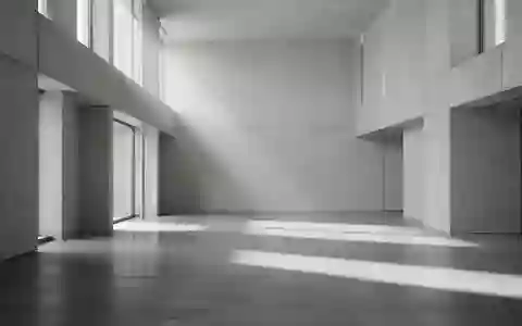 Ein minimalistischer, leerer Raum mit poliertem Betonboden und geometrischen SchattenwĂĽrfen durch einfallendes Tageslicht. - Foto: ĂĽber boerse-global.de