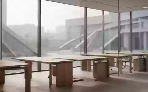 Ein minimalistisch gestalteter Büroraum mit Holztischen und einfallendem Tageslicht vor einem urbanen Hintergrund. - Foto: über boerse-global.de