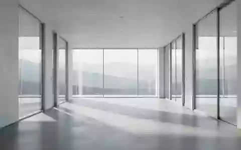 Ein minimalistischer, lichtdurchfluteter Flur mit poliertem Betonboden und Blick auf eine ruhige Landschaft. - Foto: über boerse-global.de