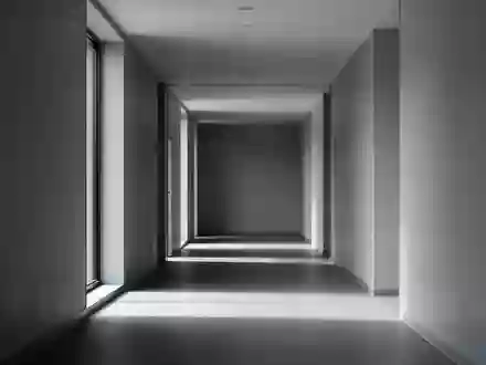 Ein leerer, minimalistischer Flur in einem modernen Gebäude mit neutralen Wänden und weichem Tageslicht. - Foto: über boerse-global.de