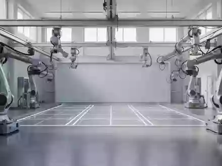 Ein minimalistisches, hochmodernes Robotik-Labor mit einer leeren Testarena und industriellen Roboterarmen. - Foto: über boerse-global.de