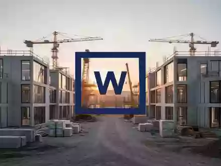 Moderne modulare Bürogebäude auf einer Baustelle bei Sonnenaufgang als Symbol für wirtschaftliches Wachstum. - Foto: über boerse-global.de