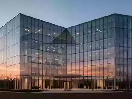 Modernes Bürogebäude in der Abenddämmerung mit klaren architektonischen Linien und Glasfassade. - Foto: über boerse-global.de